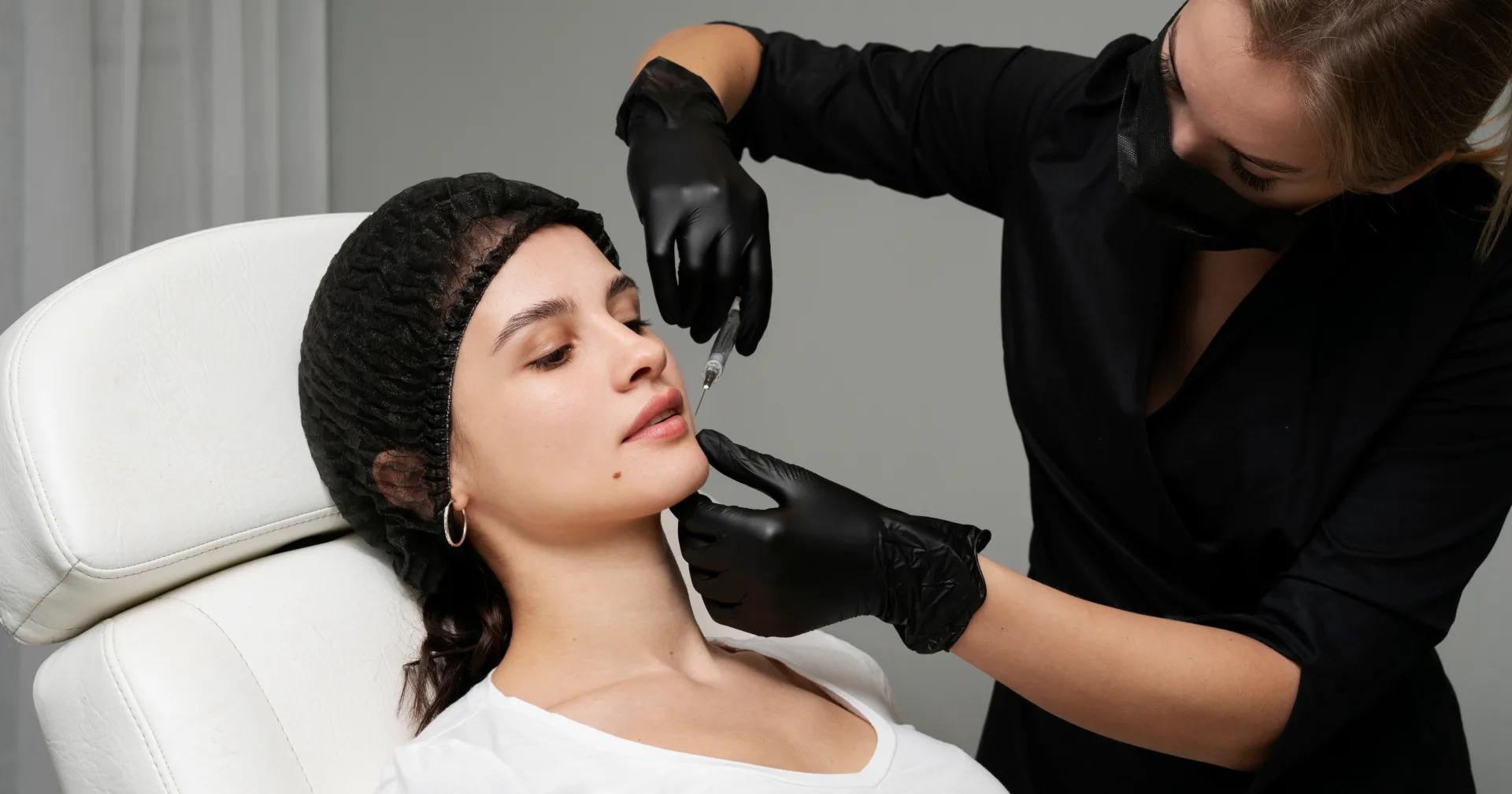 A clinician administering a dermal filler treatment